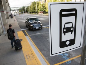 An Uber passenger meets his car at the new rideshare loading zone at the Ottawa International Airport.