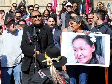 Annie Pootoogook's cousin, Sytukie Joamie (centre), addresses the crowd alongside Pootoogook's brother, Pauloosie Joanasie (centre left), and her cousin, Kilatja Simeonie (holding her picture), without realizing PM Trudeau had snuck into the crowd behind him. Prime Minister Justin Trudeau, along with a number of his female cabinet ministers, made a surprise visit to a vigil for missing and murdered Indigenous women, girls and Two-Spirit people (MMIWG2S) Tuesday (Oct. 4, 2016) on Parliament Hill.
