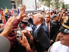 Donald Trump greets supporters outside of Trump Towers in Manhattan on Saturday, Oct. 8, 2016. The Donald Trump campaign has faced numerous calls for him to step aside after a recording from 2005 revealed lewd comments Trump made about women.