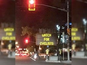 New electronic road signs on O'Connor Street warn "left turning vehicles" to "watch for cyclists" on the recently-opened segregated bike lane.