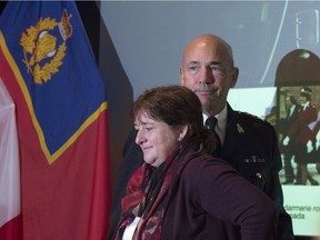 RCMP commissioner Bob Paulson passes plaintiff Janet Merlo as he leaves the stage following an announcement on RCMP harassment related litigation in Ottawa, Thursday October 6, 2016. Paulson has apologized to hundreds of current and former female officers and employees for alleged incidents of bullying, discrimination and harassment.