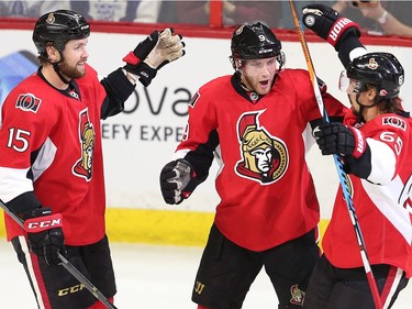 Bobby Ryan celebrates his goal with Zack Smith, left, and Erik Karlsson, right, in the first period.