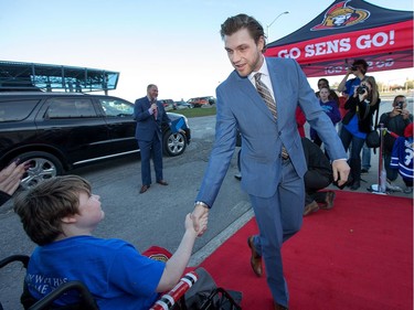 Bobby Ryan greets Hunter Graham, 14, during the red carpet event as the Ottawa Senators get set to take on the Toronto Maple Leafs in NHL action at the Canadian Tire Centre. Wayne Cuddington/ Postmedia