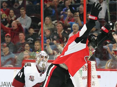 Bobby Ryan his goal in front of goalie Mike Smith in the first period.