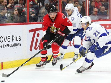 Bobby Ryan of the Ottawa Senators is defended by Valtteri Filppula (51) and Brayden Point (R)  of the Tampa Bay Lightning.