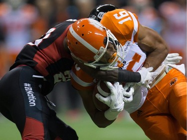 B.C. Lions' Bryan Burnham, right, is stopped at the one-yard-line by Ottawa Redblacks' Forrest Hightower during the first half of a CFL football game in Vancouver, B.C., on Saturday October 1, 2016.