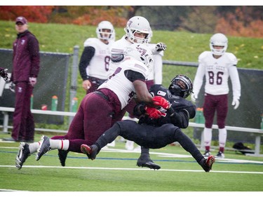 Carleton Raven's #2 Tunde Adeleke is tackled after a big play.