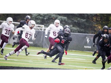 Carleton Raven's #2 Tunde Adeleke gets the ball away to make a big play during the game against Ottawa University Gee-Gee's at Carleton's Athletic Field Saturday October 29, 2016  Ashley Fraser / Postmedia