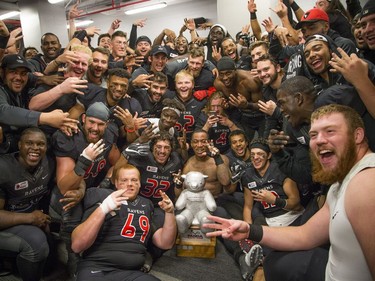 The Carleton Ravens celebrate their win in the 48th Panda Game against the University of Ottawa Gee-Gees in the locker-room at TD Place on Saturday, Oct. 1, 2016.