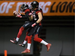 Ottawa Redblacks' Chris Williams, left, and Greg Ellingson celebrate Williams' touchdown against the B.C. Lions during the first half of a CFL football game in Vancouver, B.C., on Saturday October 1, 2016.