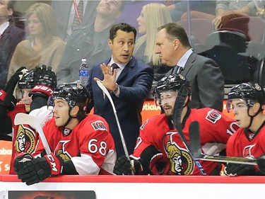 Coach Guy Boucher gives instructions to Assis Coach Martin Raymond in the first period.