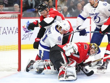 Craig Anderson of the Ottawa Senators makes the save as Mark Borowiecki battles against Brayden Point of the Tampa Bay Lightning during the second period at the Canadian Tire Centre on Saturday, Oct. 22, 2016.