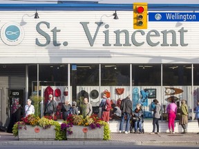 Customers line up outside St. Vincent de Paul thrift store on Wellington Street on Friday before the store's 9 a.m. opening, hoping to be first to get at the items in the window.