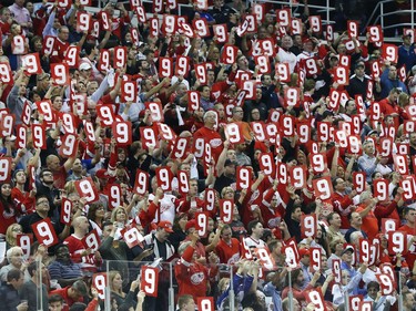 Detroit Red Wings fans hold up the number 9 in honor of the late Gordie Howe in the first period.