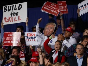 Supporters of then-Republican presidential candidate Donald Trump cheer during a campaign rally, Thursday, Oct. 27, 2016, in Geneva, Ohio.