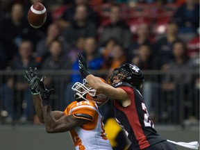 The B.C. Lions' Emmanuel Arceneaux, left, makes a reception as the Ottawa Redblacks' Mitchell White defends during the first half of a CFL game in Vancouver on Saturday, Oct. 1, 2016.