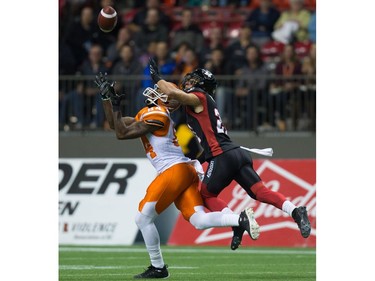 B.C. Lions' Emmanuel Arceneaux, left, makes a reception as Ottawa Redblacks' Mitchell White defends during the first half of a CFL football game in Vancouver, B.C., on Saturday October 1, 2016.
