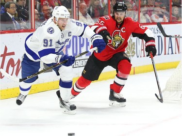 Erik Karlsson of the Ottawa Senators defends against Steven Stamkos of  the Tampa Bay Lightning.