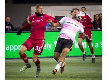 The Fort Lauderdale Strikers' Amauri tries to keep the ball away from Ottawa Fury defender Rafael Alves.