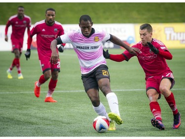 The Fort Lauderdale Strikers' Luis Zapata keeps the ball from the Ottawa Fury's Carl Haworthat.
