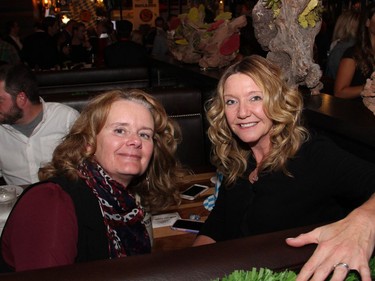 From left, Lynne Clark and Shannon Gorman, national director of community affairs at Telus, hanging out together in a comfy restaurant booth at the Capital Oktoberfest benefit for the University of Ottawa Heart Institute, held at the Bier Markt on Sparks Street on Wednesday, October 5, 2016.