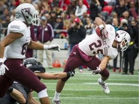 The Gee-Gees' Bryce Vieira fights to keep his balance during the 48th Panda Game.