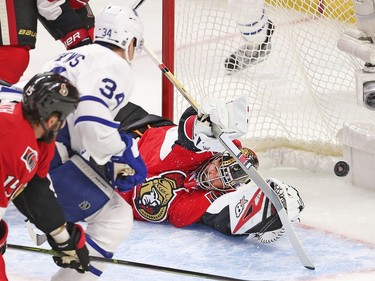 Goalie Craig Anderson tries in vain to stop from Auston Matthews scoring his first NHL goal in the first period.