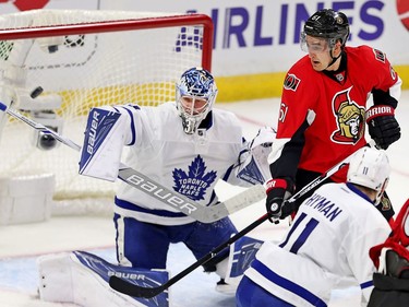 Goalie Frederik Andersen blocks a shot while Mark Stone looks on in the first period.
