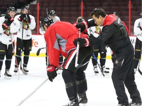 Guy Boucher, Ottawa Senators coach, coaches body positioning with Mark Borowiecki during practice at Canadian Tire Centre, October 13, 2016.