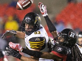 Hamilton receiver Andy Fantuz has the ball knocked away by Abdul Kanneh during the first half.