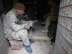 A soldier from A-Company 2 PPCLI sits near the entrance of his bunker made from Hesco barriers. Photo courtesy Canadian Forces.
