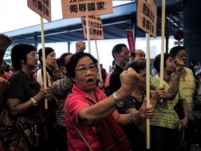HONG KONG - OCTOBER 19:  Protesters hold placards and shout slogans outside of the Legislative Council Building on October 19, 2016 in Hong Kong. Pro-Beijing legislators staged a walkout of Hong Kong's legislature on Wednesday and prevented the swearing-in of two newly-elected pro-independence Hong Kong lawmakers Yau Wai-ching and Sixtus Leung, seeking to push for independence for the autonomous region. The two radical activist are part of a new wave of activist candidates who were elected last month during the Legislative Council election which saw a rise in anti-China sentiment in Hong Kong.