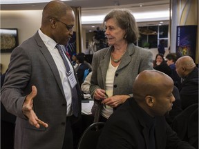 Justice Michael Tulloch speaks with Suzanne Labbe during a public consultation by the Independent Police Oversight review at the Wabano Centre in Ottawa on Wednesday October 26, 2016.