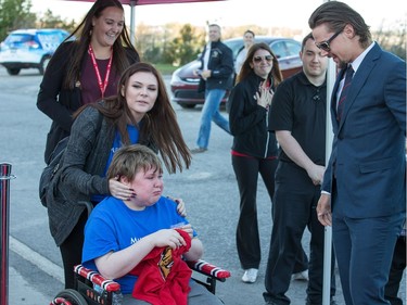 Hunter Graham, 14, seen with his sister Tamer Graham, 16, is overcome with emotion as he meets Erik Karlsson (R) as part of his "Make A Wish" during the red carpet event outside the arena as the Ottawa Senators get set to take on the Toronto Maple Leafs in NHL action at the Canadian Tire Centre. Wayne Cuddington/ Postmedia