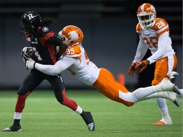 B.C. Lions' Darius Allen, right, dives to tackle Ottawa Redblacks' Jamill Smith, who fumbled the ball on the play leading to a turnover, during the first half of a CFL football game in Vancouver, B.C., on Saturday October 1, 2016.