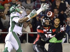 The Ottawa Redblacks' Chris Williams (80) catches the ball to score a touchdown as he is defended by Saskatchewan Roughriders' Justin Cox (31) during first-half action on Friday, Oct. 7, 2016 in Ottawa.