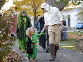 Prime Minister Justin Trudeau, dressed as the Pilot from The Little Prince, right, and his son Hadrien, dressed as the Little Prince, arrive at Rideau Hall to go trick-or-treating, on Halloween, Monday, Oct. 31, 2016 in Ottawa.