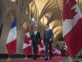Canadian Prime Minister Justin Trudeau and French Prime Minister Manuel Valls walk through the Hall of Honour on Parliament Hill in Ottawa, Thursday October 13, 2016.