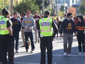 Kingston Police watch over an "open" Aberdeen Street during Queen's University Homecoming 2016 in Kingston, Ont. on Saturday, Oct. 15.