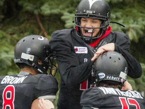 From left, the Carleton Ravens' Phil Iloki, Wilson Birch and Kyle VanWynsberghe celebrate in the end zone during the game against Ottawa University Gee-Gees at MNP Park on Saturday, Oct. 29, 2016.