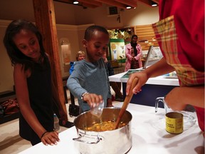 From left, Kafia, 9, and Kaleb Ahmed, 6, help make Three Sisters Soup at the Canada Agriculture and Food Museum, which is offering workshops and activities to celebrate Thanksgiving and the harvest.