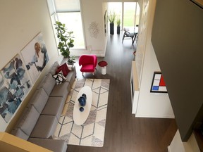 The living room inside the Hutton model by HN Homes on Summerhill Street in Riverside South features a two-storey fireplace.