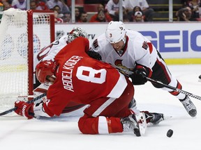 Ottawa Senators defenseman Marc Methot (3) checks Detroit Red Wings' Justin Abdelkader (8) off the puck in the second period of an NHL hockey game at Joe Louis Arena, Monday, Oct. 17, 2016, in Detroit.