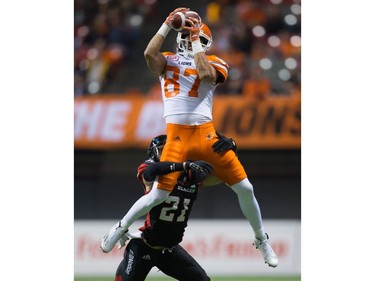 B.C. Lions' Marco Iannuzzi, top, leaps to make a reception as Ottawa Redblacks' Mitchell White defends during the second half of a CFL football game in Vancouver, B.C., on Saturday October 1, 2016.