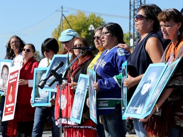 Mothers of missing children and others hold up the many faces of missing and murdered aboriginal women. Prime Minister Justin Trudeau, along with a number of his female cabinet ministers, made a surprise visit to a vigil for missing and murdered Indigenous women, girls and Two-Spirit people (MMIWG2S) Tuesday (Oct. 4, 2016) on Parliament Hill.  At far right is Kilatja Simeonie, holding a portrait of her cousin, native artist, Annie Pootoogook, who recently turned up dead in the Rideau River.
