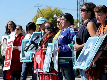 Mothers of missing children and others hold up the many faces of missing and murdered aboriginal women. Prime Minister Justin Trudeau, along with a number of his female cabinet ministers, made a surprise visit to a vigil for missing and murdered Indigenous women, girls and Two-Spirit people (MMIWG2S) Tuesday (Oct. 4, 2016) on Parliament Hill.  At far right is Kilatja Simeonie, holding a portrait of her cousin, native artist, Annie Pootoogook, who recently turned up dead in the Rideau River.