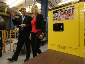 Carleton University professor Matthew Johnson and Catherine McKenna, Minister of Environment and Climate Change, take a tour of a lab before a press conference at Carleton University in Ottawa on Wednesday.