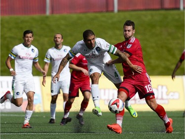 New York Cosmos player Carlos Mendes (4) kicks the ball as Ottawa Fury FC player Thomas Stewart (16) tries to block him during the NASL match between Fury FC and Cosmos held at TD Place on Sunday, Oct. 9, 2016. (James Park)