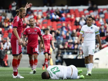 New York Cosmos player Sebastian Guenzatti lays on the ground after crashing with Ottawa Fury FC player during the NASL match between Fury FC and Cosmos held at TD Place on Sunday, Oct. 9, 2016. (James Park)