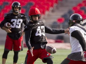 Newly signed Ottawa RedBlacks kicker Ray Early (#43) kicks a punt as kicker Zach Medeiros (#39) watches during team practice at TD Place on Monday October 17, 2016.